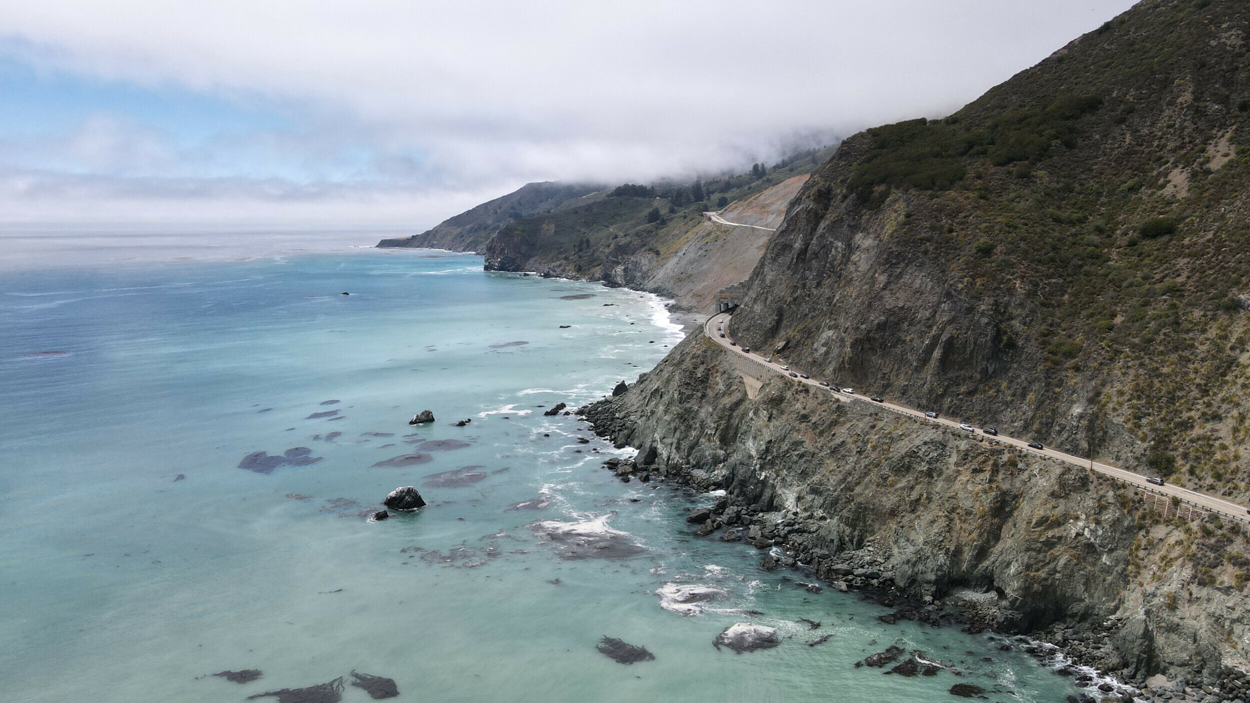 Aerial view of California's Highway 1 meandering along the Big Sur coast near Limekiln State Park.