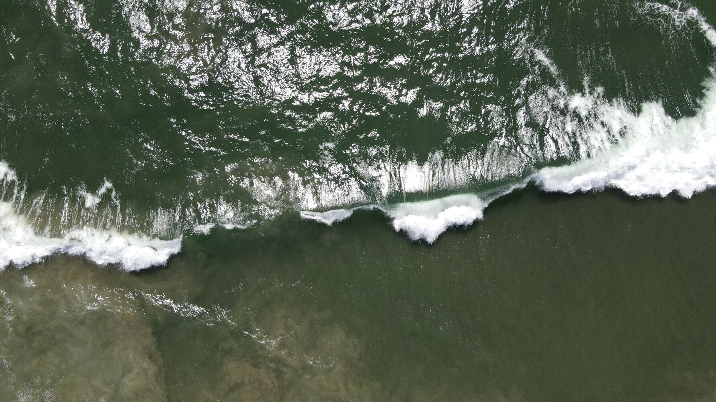 Overhead view of breaking waves captured by the DJI Mavic Air 2 at Malibu Beach, California