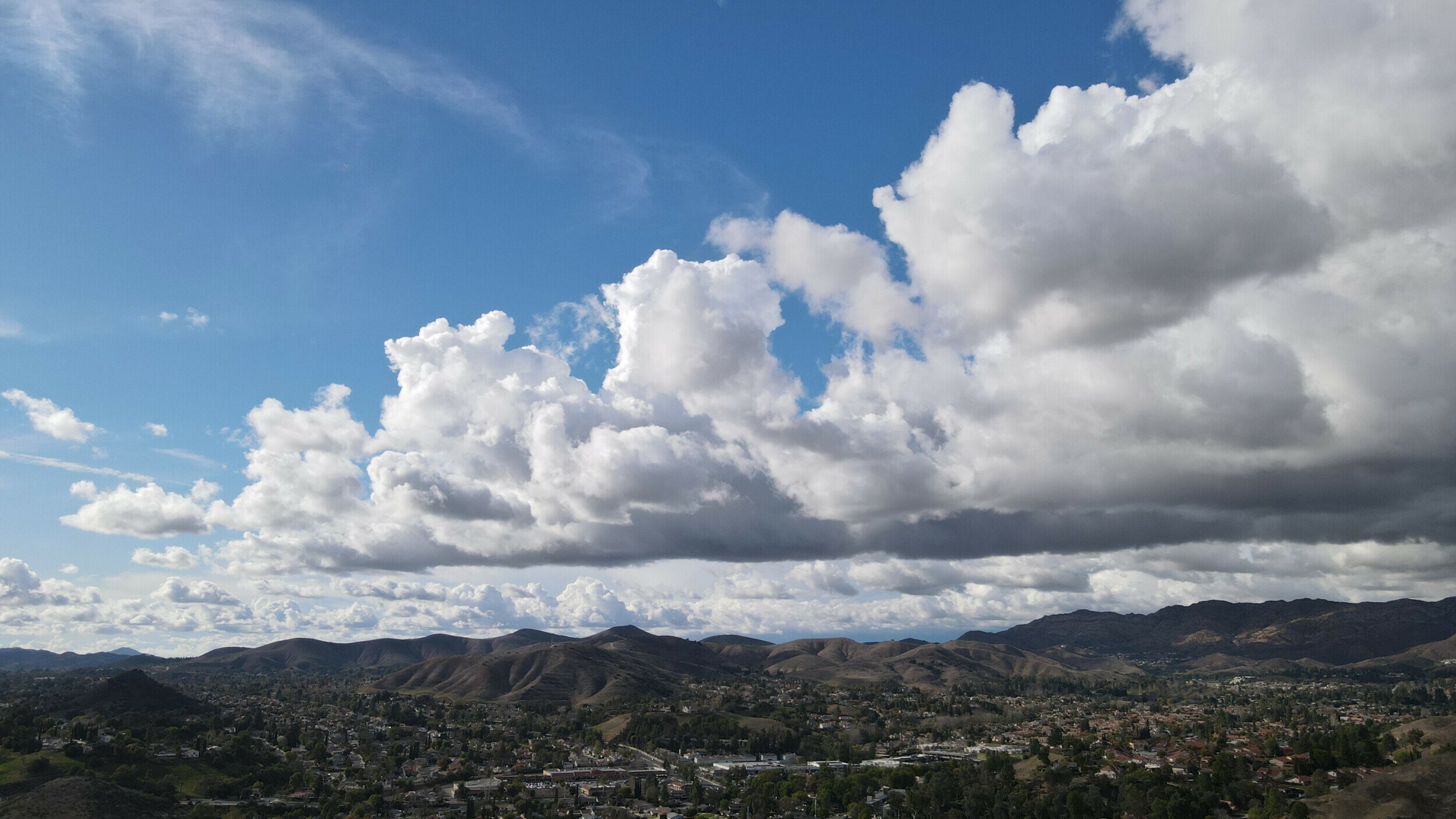 Aerial view of cloud-filled skies above the rolling landscape of Agoura Hills, taken with a DJI Mavic Air 2 drone.