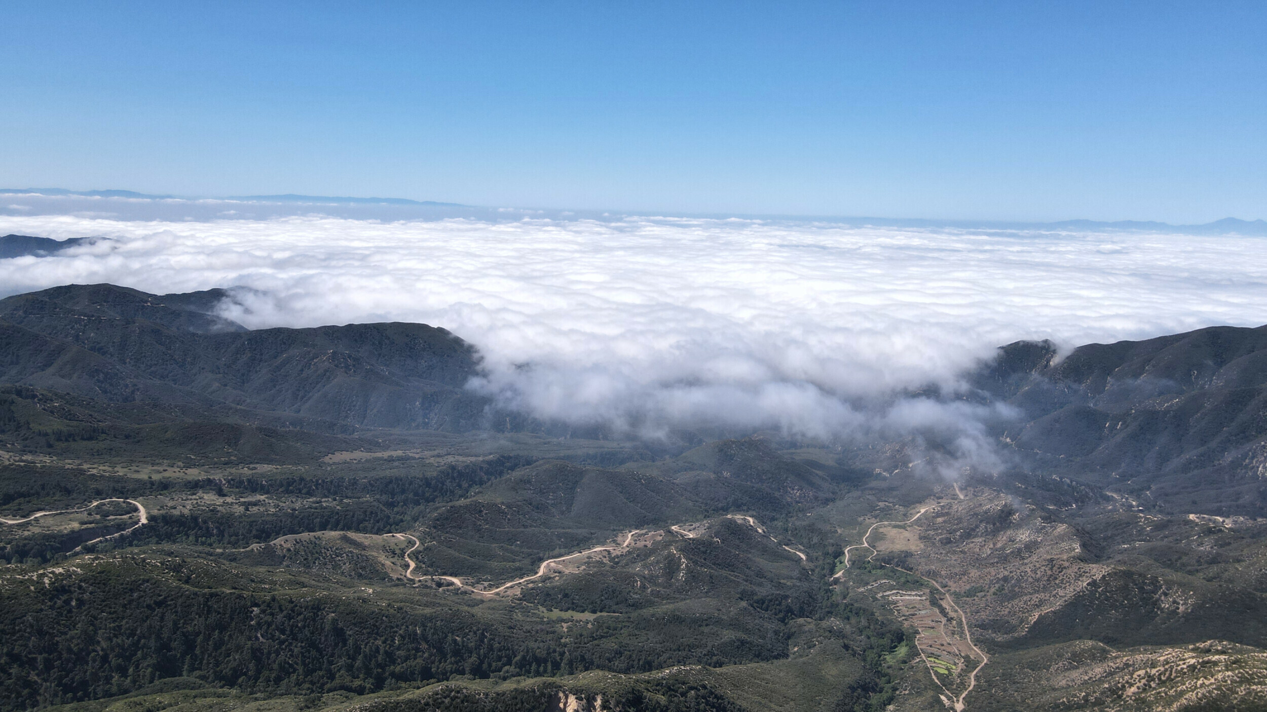 Overlooking a blanket of clouds covering the valleys of Big Bear Mountain Range in California.